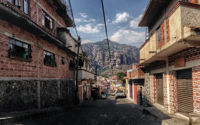 Tepozteco mountain dwarfs the village below, Tepoztlan (Photo modified from Richard Cawood original via Flickr, www.RichardCawood.com)